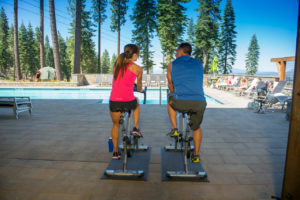 couple working out next to community pool in tahoe truckee community northstar martis